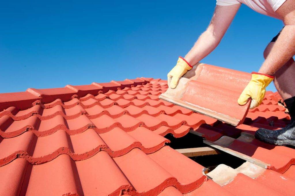roofer applying roof tiles
